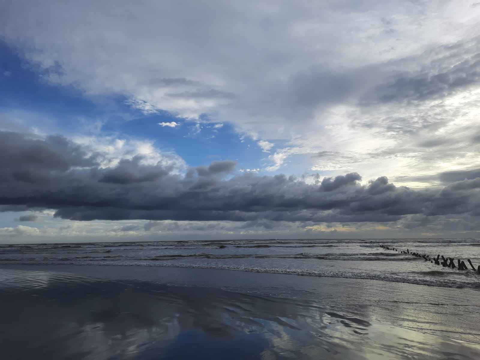 Sea turning silver, clouds curling low — as if the sky was writing something bold. - Cox’s Bazar, Bangladesh